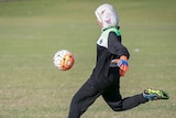 A Balga Soccer Club goalkeeper wearing a hijab punts the ball.