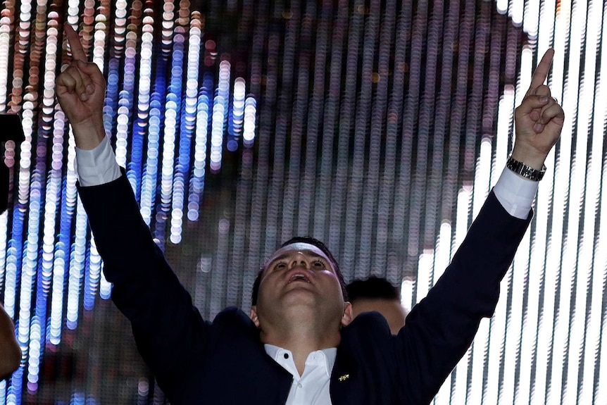 Fabricio Munoz is seen raising his hands and looking up.