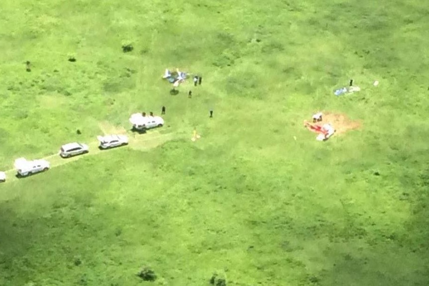 Emergency services attend the scene of the crash involving two ultralight planes. Supplied: Nine News
