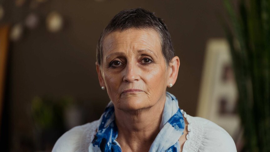 Cancer patient Jane Downs looks directly into the camera, pictured at her home.