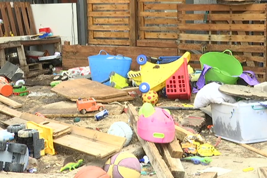 Damaged kids' toys and other items in a resident's yard.