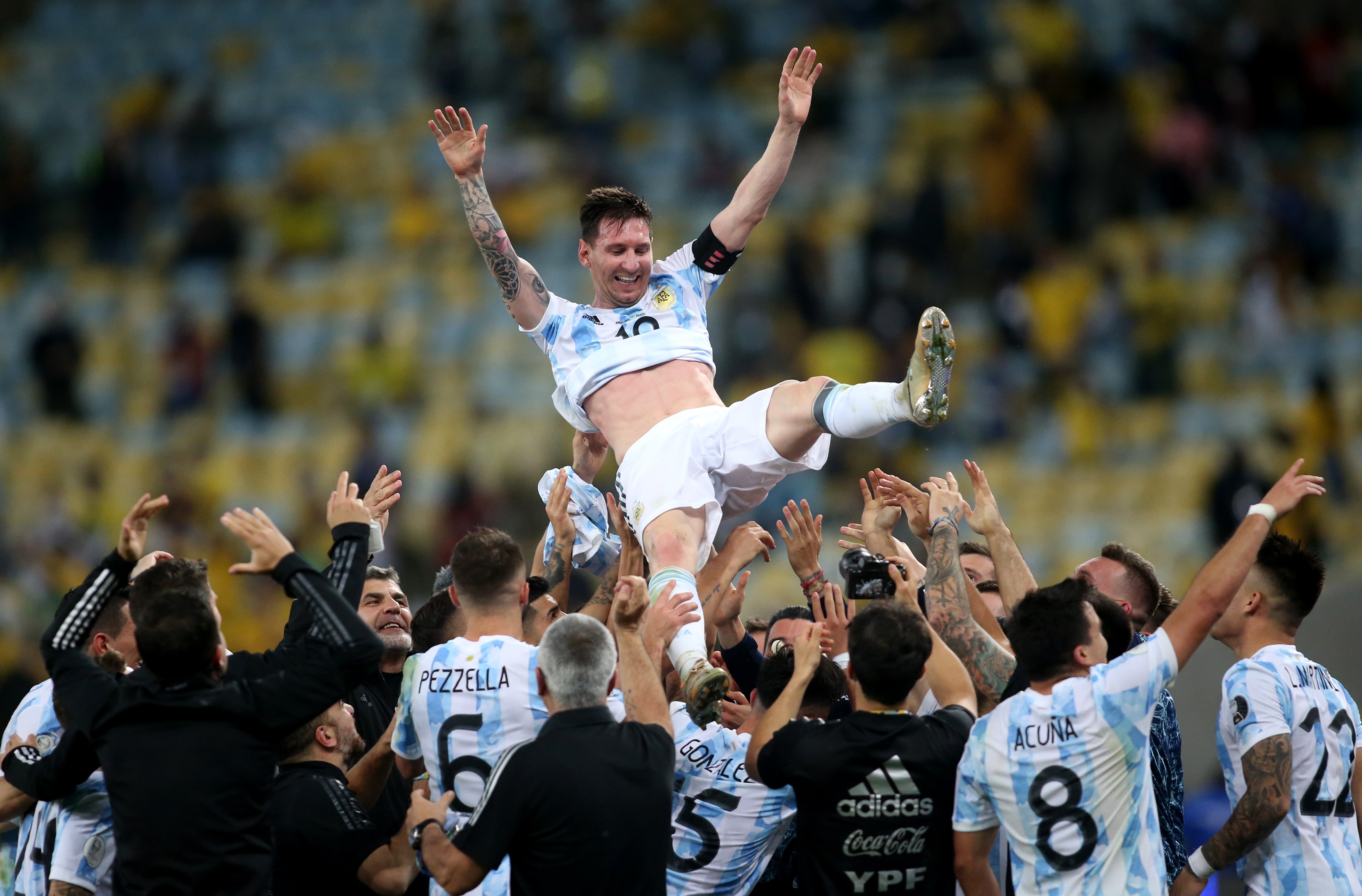 Players of Argentina lift in the air their Captain Lionel Messi into the air