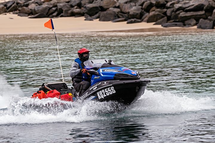 A man on a jetski powers through the water