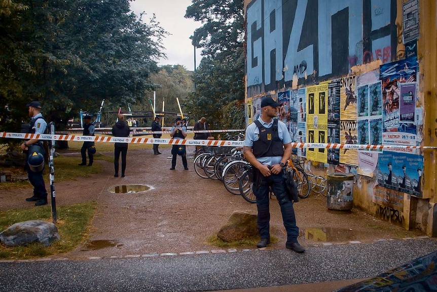 Police outside a building with police tape around it