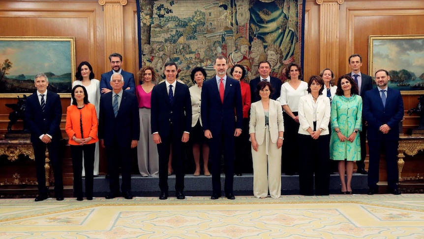 King Felipe, new Prime Minister Pedro Sanchez and his members of government pose for a photograph.