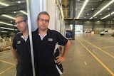 Stefan Styles standing next to a mirror in the warehouse of of Civic Shower Screens and Wardrobes in Brisbane