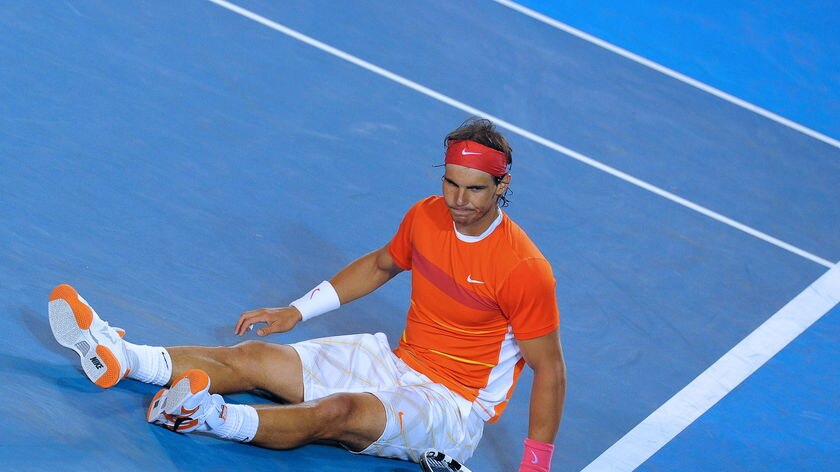 Floored: Nadal's knee forced him out of the race for back-to-back Australian Open titles.