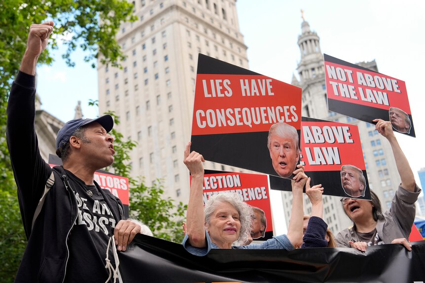 Protesters against Trump hold up sides reading lies have consequences and not above the law.