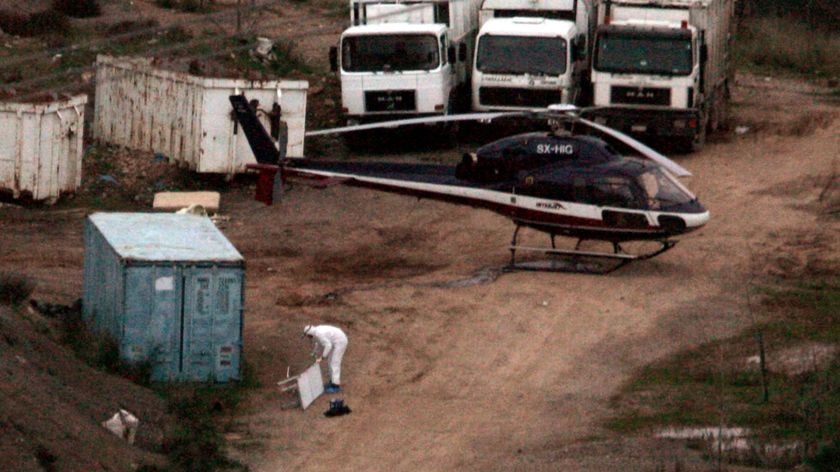 Police forensic experts investigate a helicopter