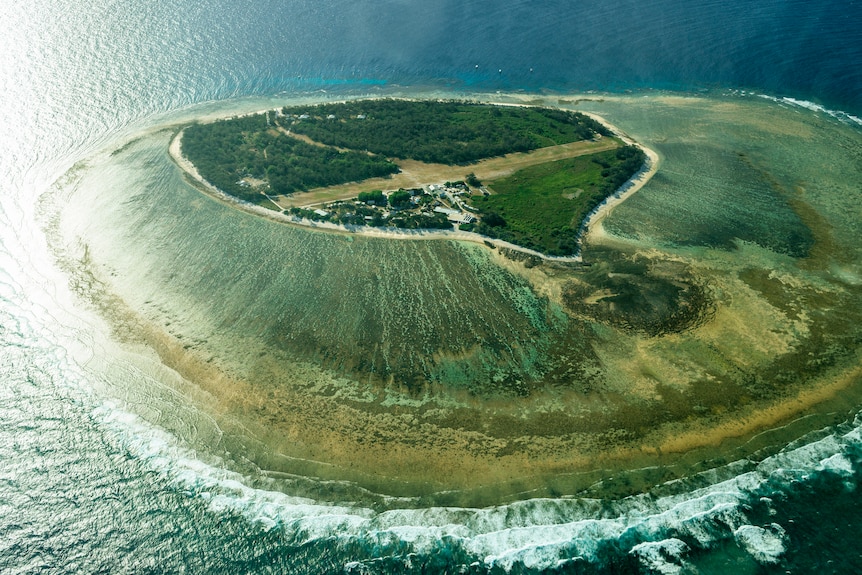 Aerial shot of Lady Eliot Island in Queensland, showing the land surrounded by the ocean.