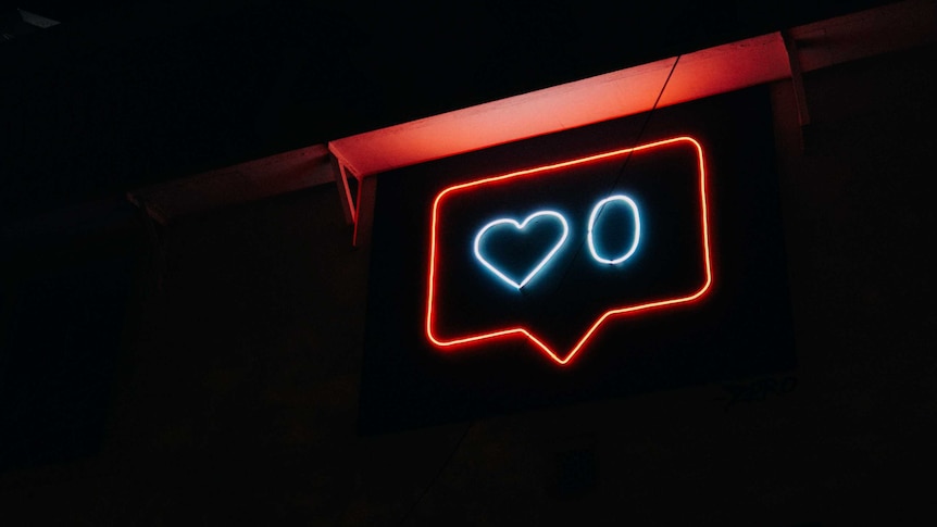 A neon side displaying a love heart next to the number zero.