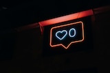 A neon side displaying a love heart next to the number zero.