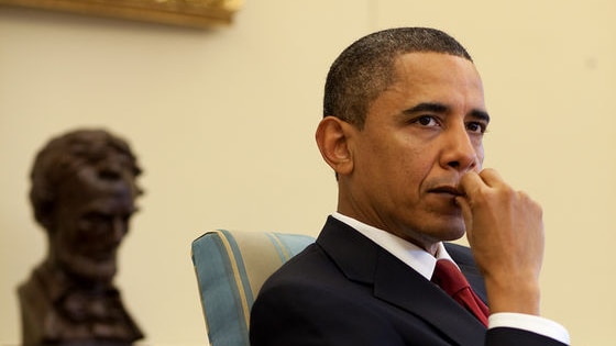 US President Barack Obama listens during a meeting with senior advisors in the Oval Office.