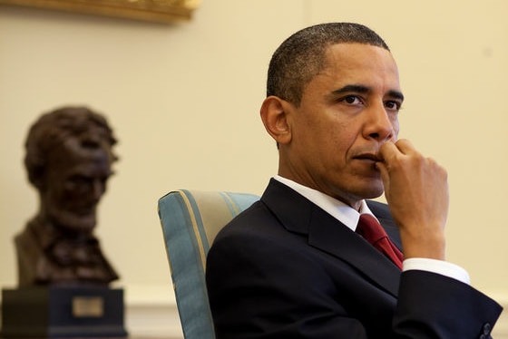 US President Barack Obama listens during a meeting with senior advisors in the Oval Office.
