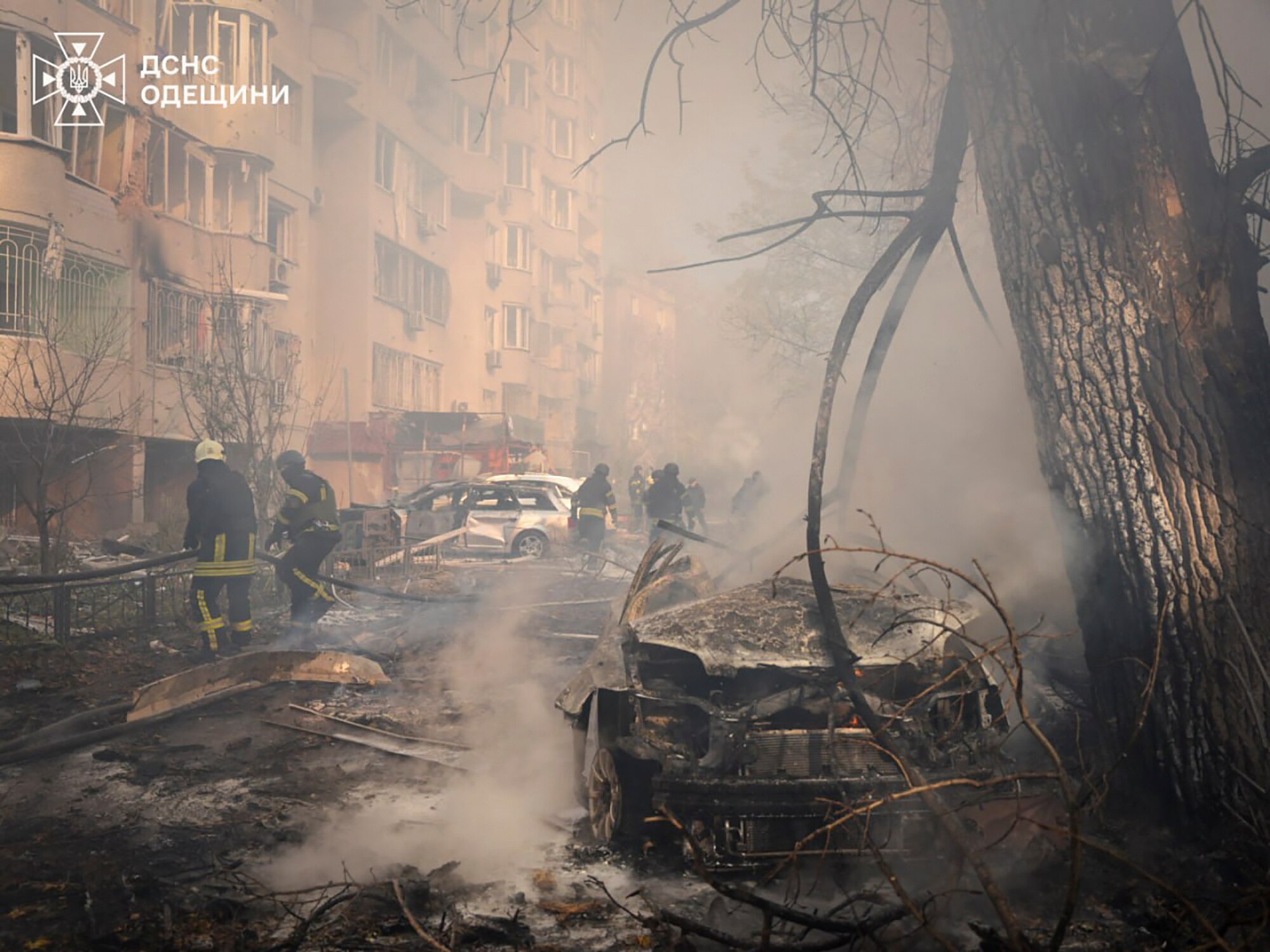 Firefighters work to extinguish a fire that has broken out following a missile strike
