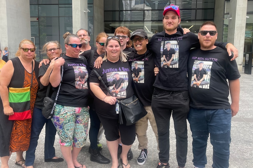 Benjamin Suttie's family outside court with tshirts with ben's face on them