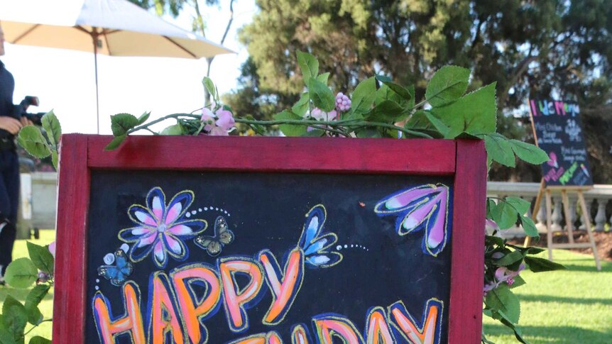 Happy Birthday sign on a chalkboard at Prince Charles' party in Cottesloe