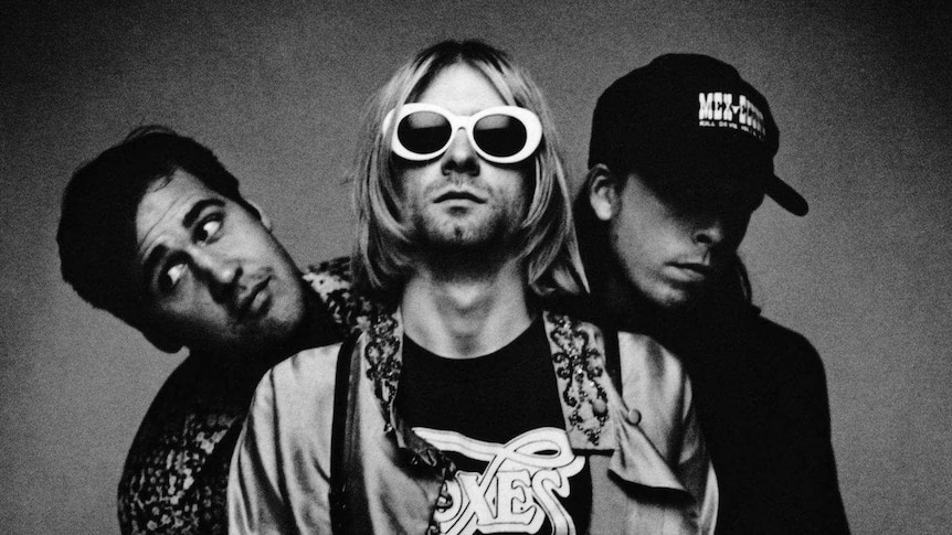 The three members of Nirvana pose for a photo.