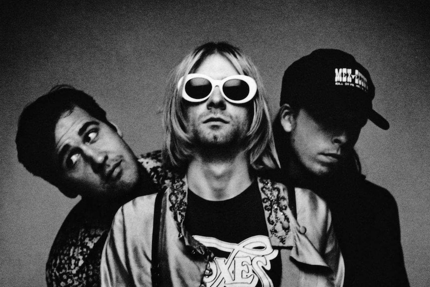 The three members of Nirvana pose for a photo.