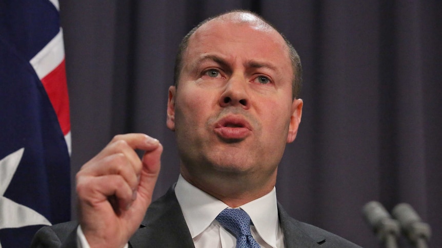 Josh Frydenberg gestures during a press conference.