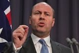 Josh Frydenberg gestures during a press conference.