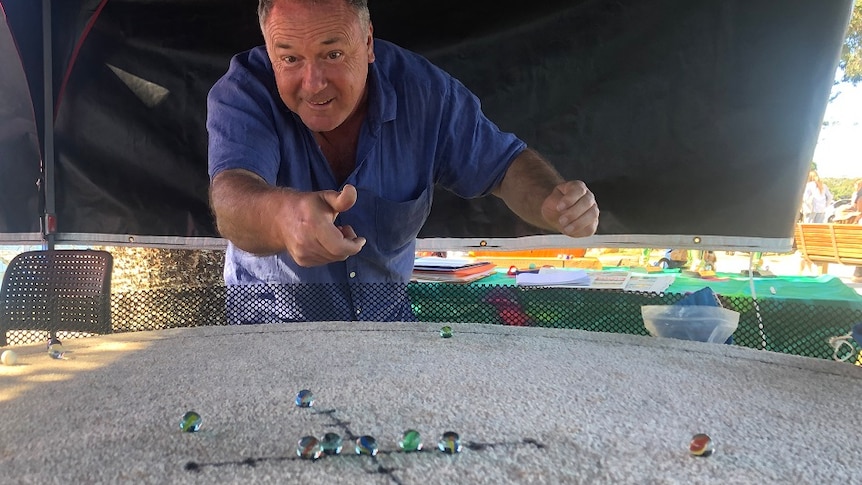 Man playing marbles