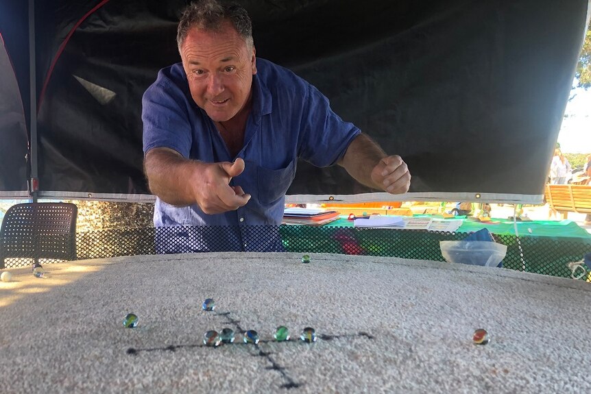 Man playing marbles