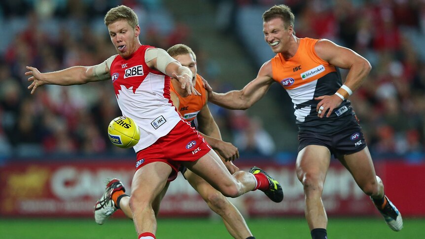 The Swans' Daniel Hannebery celebrates his goal in Sydney's 94-point win over the Giants.
