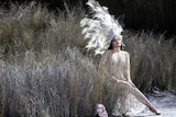 A woman wearing a feathered headdress