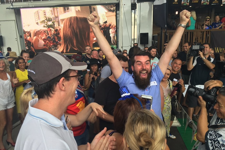 The winner of the 35th Australia Day Cockroach Races celebrates.