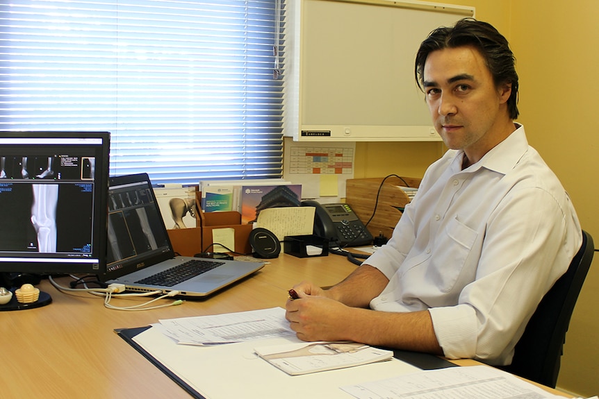 Dr Chris Phoon in his office in Bega, NSW.