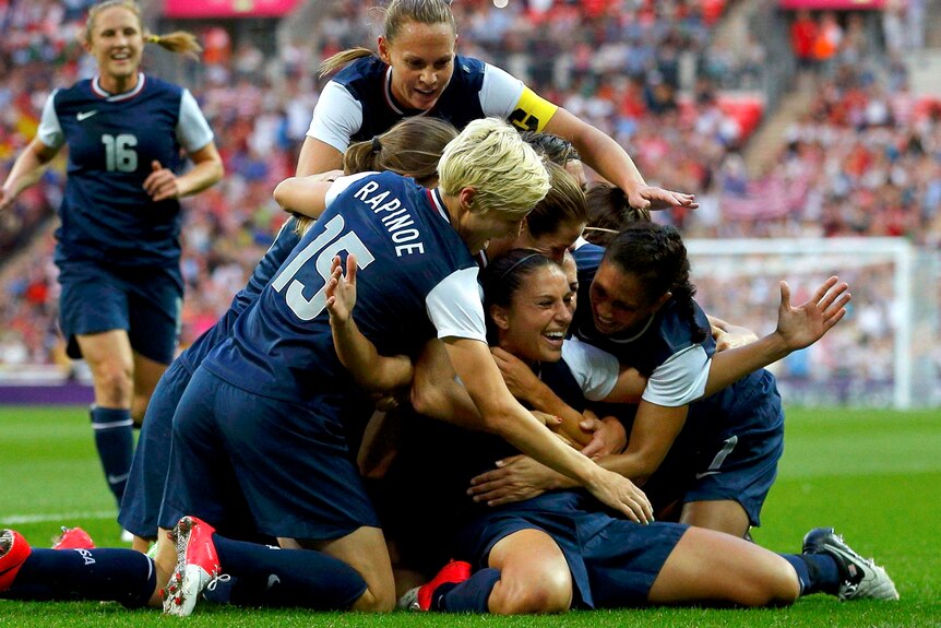 Carli Lloyd celebrates a goal with her team-mates in the gold medal match.
