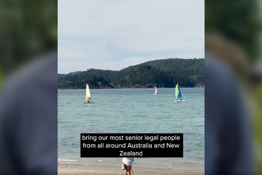 A screenshot of a video of a beach, with closed captions over the top.