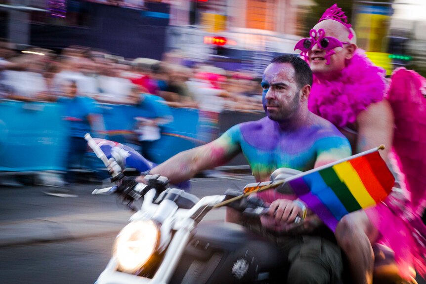 two colourful men on a motorcycle