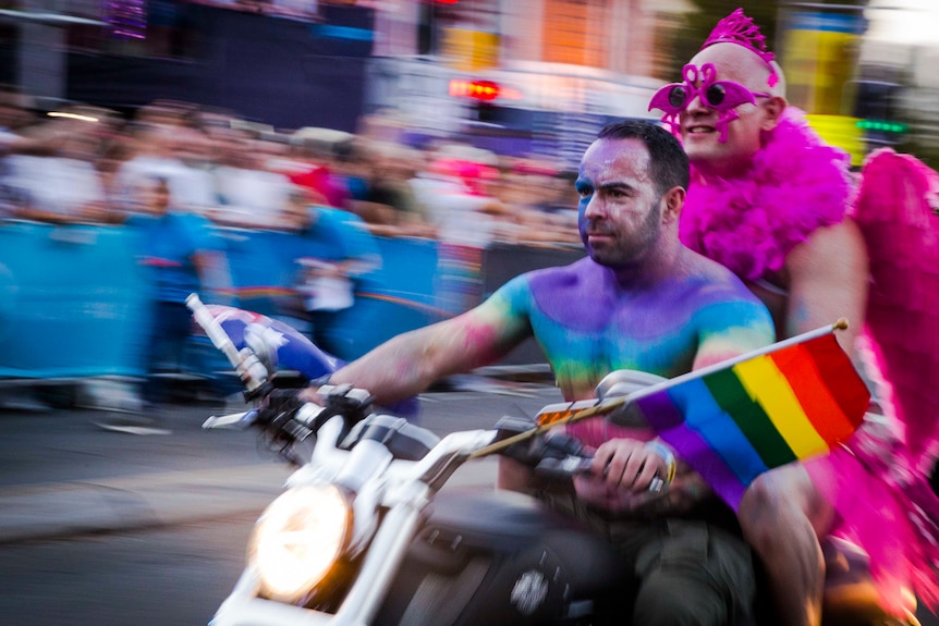 two colourful men on a motorcycle