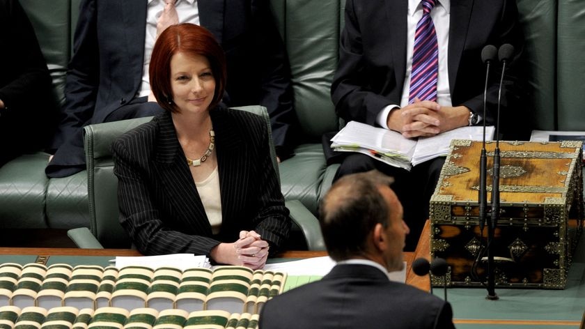 Julia Gillard listens to Tony Abbott