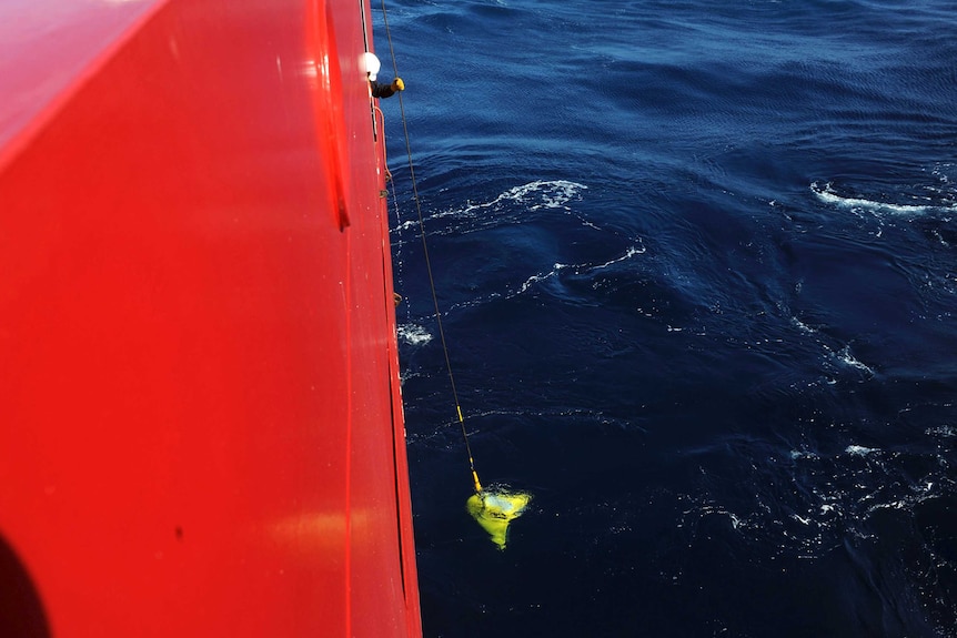 Pinger locator lowered into ocean