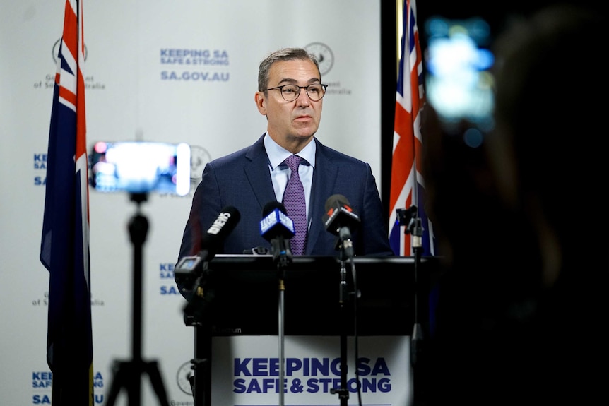 Premier Steven Marshall standing in front of microphones.