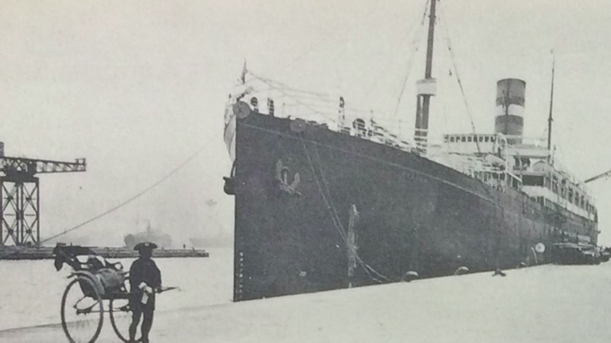 Black and white photograph of a boat docked in Yokohoma. 