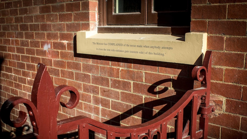 The side wall of 57 Murray Street is of red brick. The sandstone facade only covers the front.