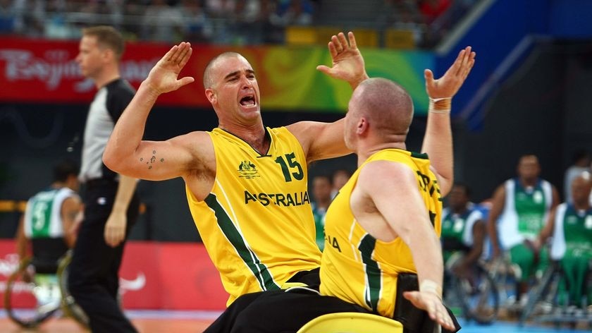 Australian wheelchair basketball players LtoR Brad Ness and Shaun Norris celebrate their preliminary match win against Brazil