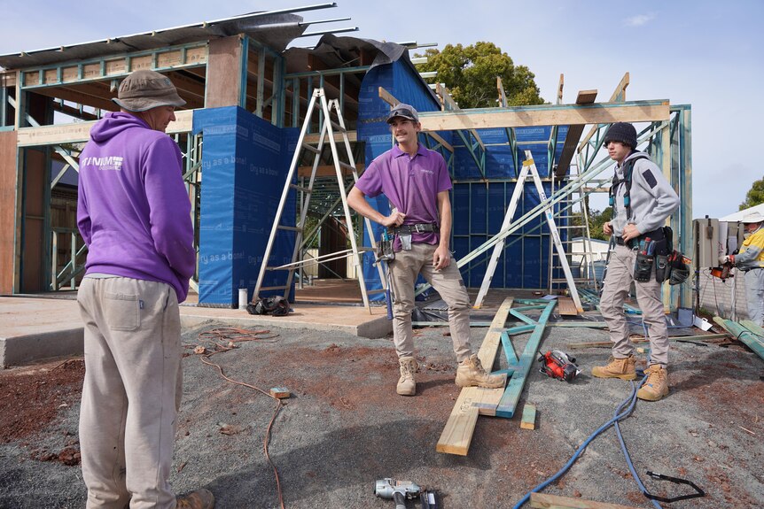 Three men at a construction site