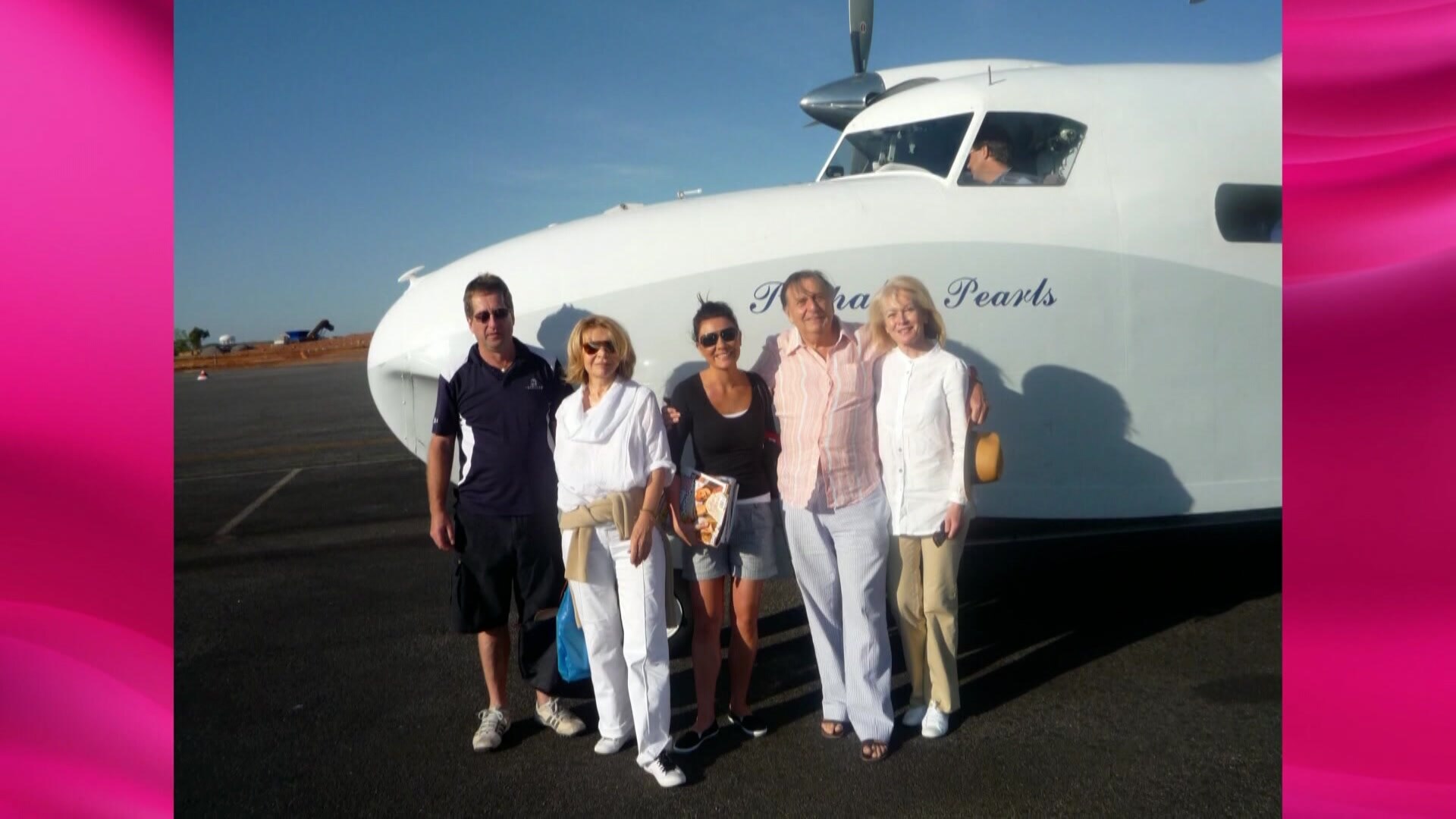 Barry Humphries stands with his family in front of a plane in an undated photo