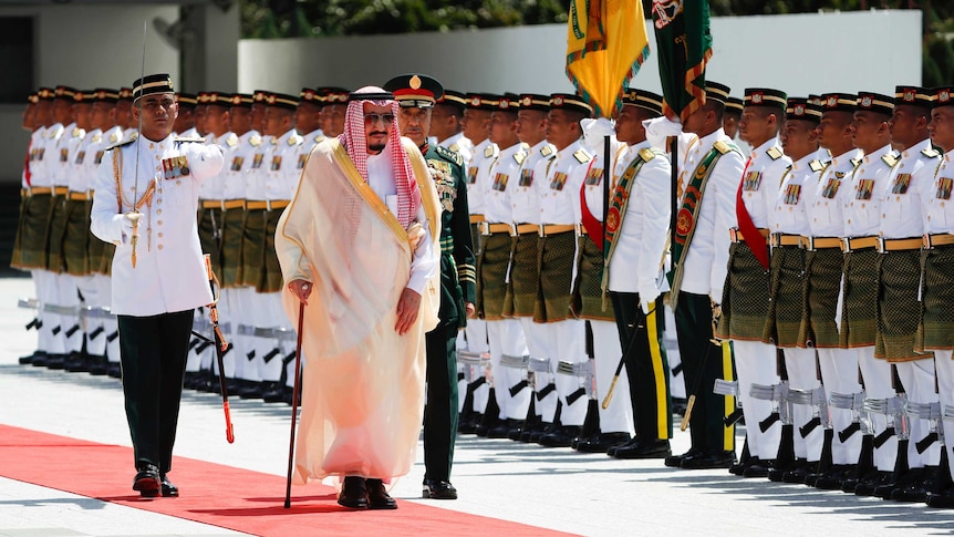 Saudi Arabia's King Salman inspects a honour guard.
