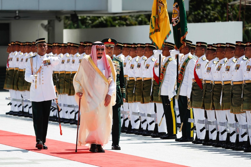 Saudi Arabia's King Salman inspects a honour guard.