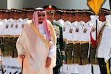 Saudi Arabia's King Salman inspects a honour guard.