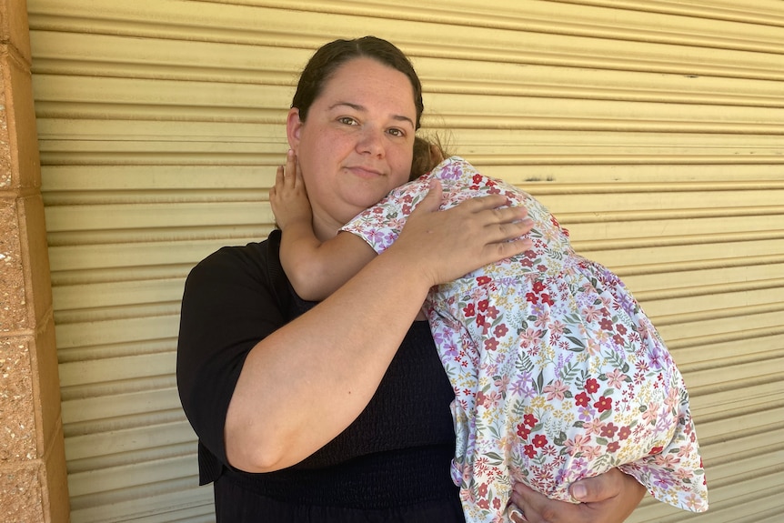 woman holds her child