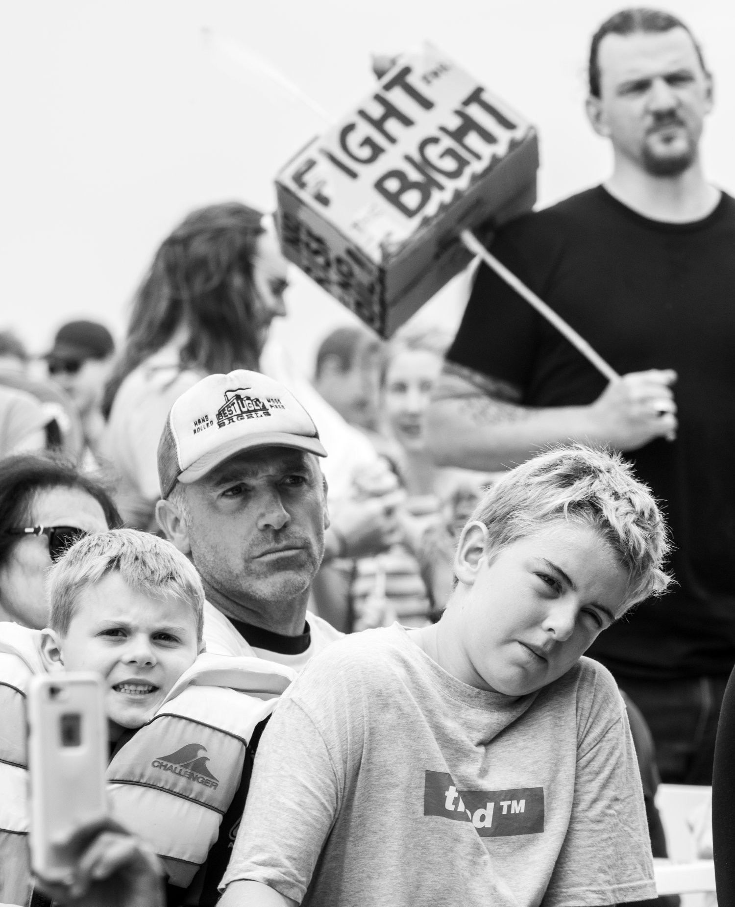 Black and white pic of a father and son, behind them a man holds a poster saying Fight for the Bight