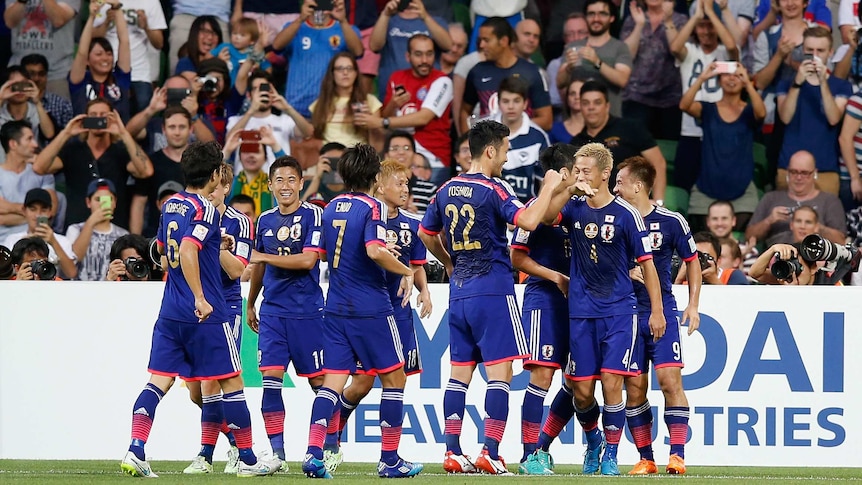 Japanese players celebrate a Keisuke Honda goal during the 2015 Asian Cup