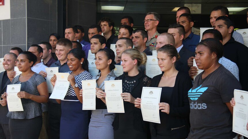New Army recruits pose for the cameras at their enlistment ceremony in Darwin.